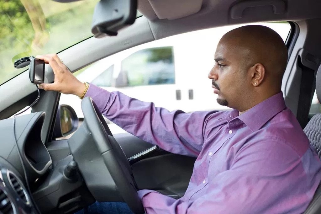 Male driver adjusts Satnav voice over settings