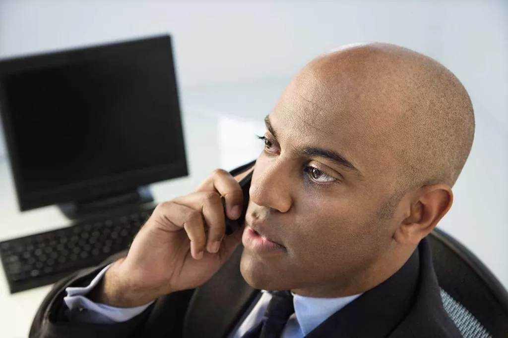 man talking on the phone looking very interested